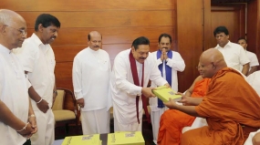 Book titled &quot; Siri Dalada Harasaraniya &quot;  presented to President