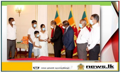 Foreign Minister Peiris hands over a financial grant to the family of  late Priyantha Kumara